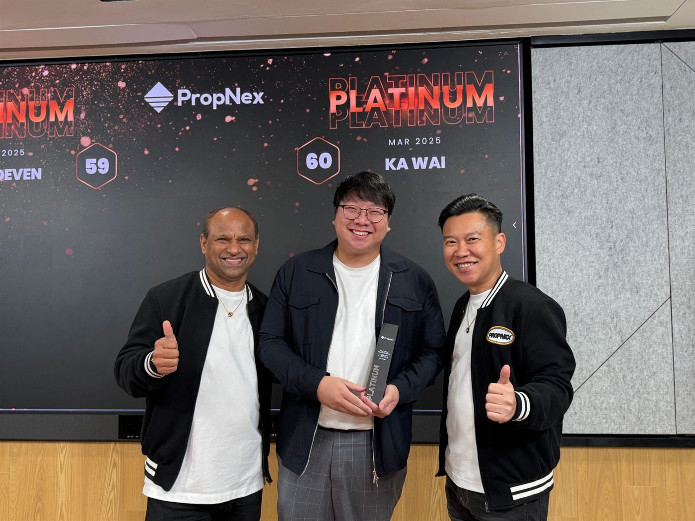 Ka Wai holding the PropNex Platinum Achiever trophy, March 2025