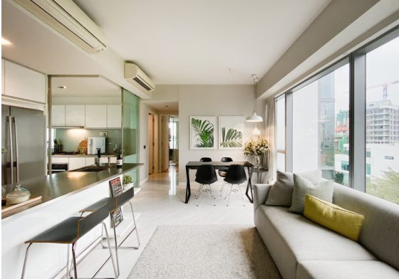 Wide-angle listing photo of a living and dining area with city view